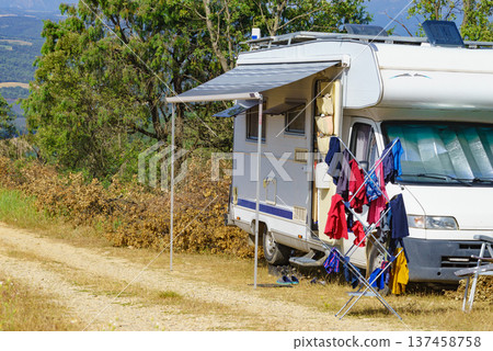 Clothes hanging to dry outdoors by camping car. Caravan vacation. Clothes hanging to dry outdoors by camping car. Caravan vacation. 137458758