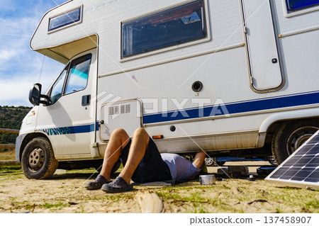 Man repairing bottom of the rv caravan Man repairing bottom of the rv caravan 137458907
