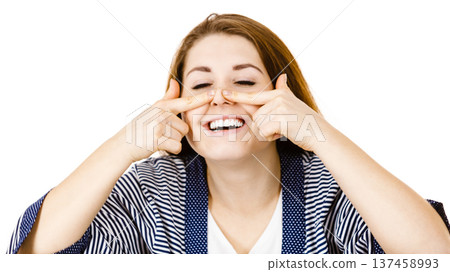 Happy cheerful woman touching her nose 137458993