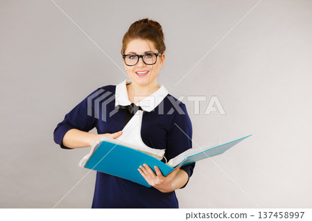 Happy positive business woman holding binder with documents 137458997