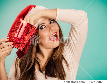 Christmas woman puts her hand into gift bag Christmas woman puts her hand into gift bag 137459029