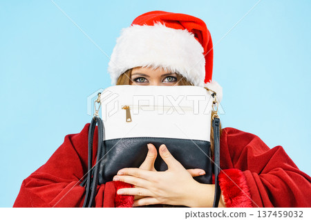 Christmas girl holding handbag present Christmas girl holding handbag present 137459032