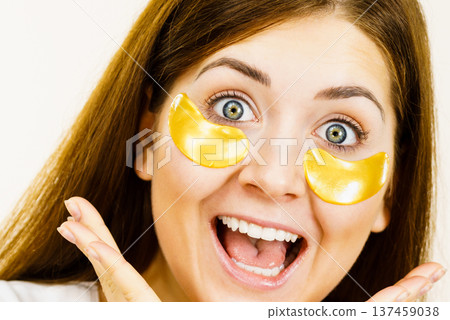 Woman with gold patches under eyes Woman with gold patches under eyes 137459038