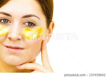Woman with gold patches under eyes Woman with gold patches under eyes 137459042