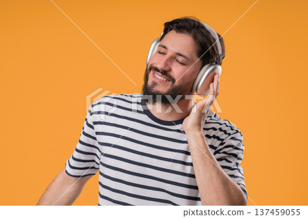 Mature White Man Gets High, Listening Music With Headphones On Yellow Studio. Radio, wireless modern Mature White Man Gets High, Listening Music With Headphones On Yellow Studio. Radio, wireless modern 137459055