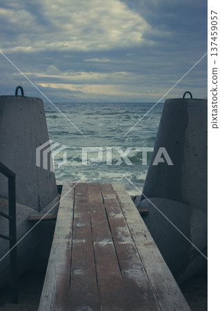 Dramatic winter seascape with wooden pier and tripods. Black Sea coast with wooden board path. Seaside on bad weather day. Aerial view of Black Sea. Travel in Ukraine. Dramatic seascape background. Dramatic winter seascape with wooden pier and tripods. Black Sea coast with wooden board path. Seaside on bad weather day. Aerial view of Black Sea. Travel in Ukraine. Dramatic seascape background. 137459057