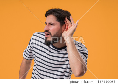 Mature Man Pointing To Ear With Confused Face, Signaling He Cant Hear Clearly 137459061
