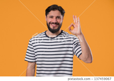 Positive Mature man With Ok, Okay Hand Sign Gesture. Happy Guy On yellow studio Positive Mature man With Ok, Okay Hand Sign Gesture. Happy Guy On yellow studio 137459067