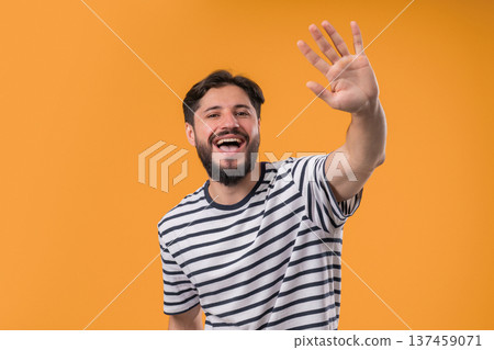 Friendly 30S Aged Man Waving Hand - Hello, Hi, Salute, Chao. Greetings On Yellow 137459071