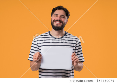 Happy man Holding Horizontal White A4 Paper Poster. Copy Space. Mock-Up Banner 137459075