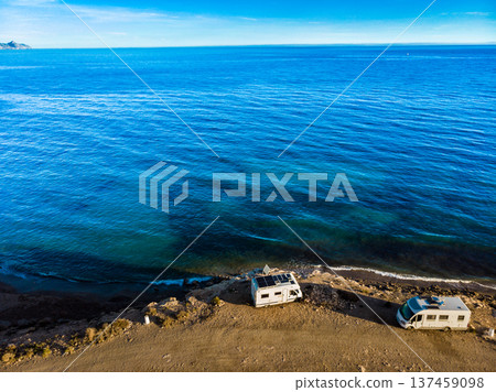 Two caravans solar panels on roof camp on seashore. Aerial view 137459098