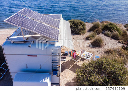 Caravan with tilt solar panels on roof. Aerial view. Caravan with tilt solar panels on roof. Aerial view. 137459109