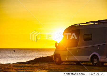 Camper car on beach at sunrise 137459173