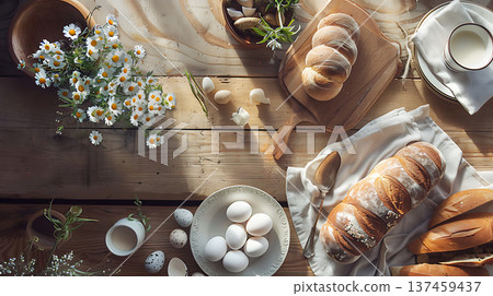 Freshly baked bread and eggs on rustic wooden table with flowers Freshly baked bread and eggs on rustic wooden table with flowers 137459437