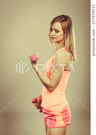 Fitness woman exercising with dumbbells. Fitness woman exercising with dumbbells. 137459513