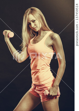 Fit woman exercising with dumbbells. Fit woman exercising with dumbbells. 137459514