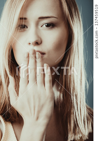 Surprised woman face covering her mouth with hand Surprised woman face covering her mouth with hand 137459519
