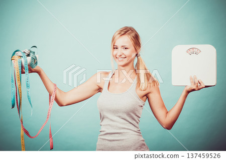 Girl with scales measuring tapes. Weight loss. Girl with scales measuring tapes. Weight loss. 137459526