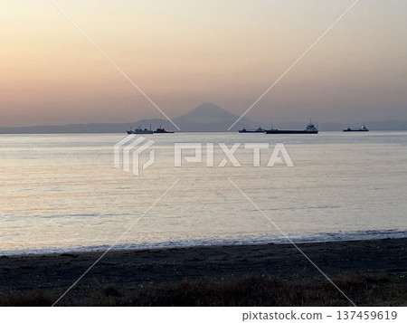 The silhouette of Mt. Fuji floating in the evening mist and a ship anchored on the sea, Tateyama City, Chiba Prefecture 137459619