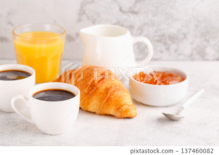 Hot coffee, croissants on a light background, selective focus. Hot coffee, croissants on a light background, selective focus. 137460082