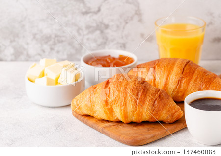 Hot coffee, croissants on a light background, selective focus. Hot coffee, croissants on a light background, selective focus. 137460083
