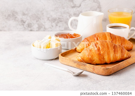 Hot coffee, croissants on a light background, selective focus. Hot coffee, croissants on a light background, selective focus. 137460084