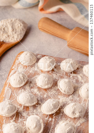 Homemade raw dumplings on the board. Homemade raw dumplings on the board. 137460115
