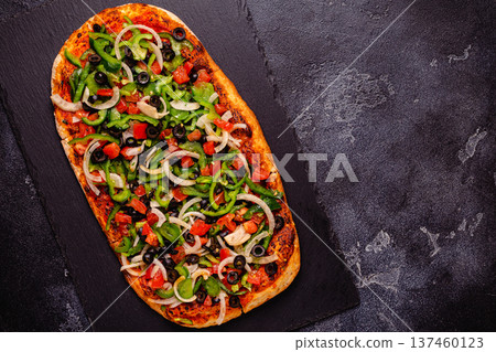 Homemade vegan pizza with tomatoes, peppers, olives, onions and herbs. Homemade vegan pizza with tomatoes, peppers, olives, onions and herbs. 137460123