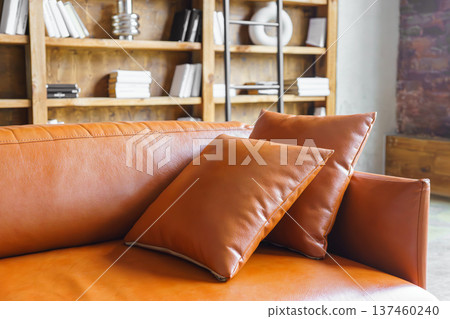 Decorative cushions on brown leather sofa in modern loft office library interior background Decorative cushions on brown leather sofa in modern loft office library interior background 137460240