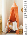 Boho interior, kids corner with orange canopy, woven bed, giraffe toy and natural rattan decor 137460246