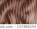 Crumpled brown knitted fabric texture with folds, wrinkles and soft waves, wool background 137460254