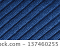 Blue colored knitted fabric, knitwear texture with diagonal soft ribbed pattern background 137460255