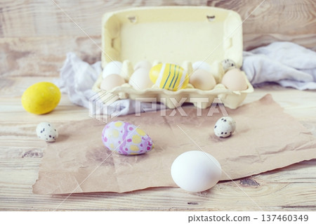 Easter, preparation for the holiday. Various colored and fresh chicken and quail eggs on a rustic wooden table. Easter, preparation for the holiday. Various colored and fresh chicken and quail eggs on a rustic wooden table. 137460349