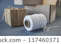 Cardboard boxes and packing twine, delivery concept. Stacking of postal cardboard boxes and packing twine. 137460371