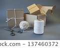 Cardboard boxes and packing twine, delivery concept. Stacking of postal cardboard boxes and packing twine. 137460372