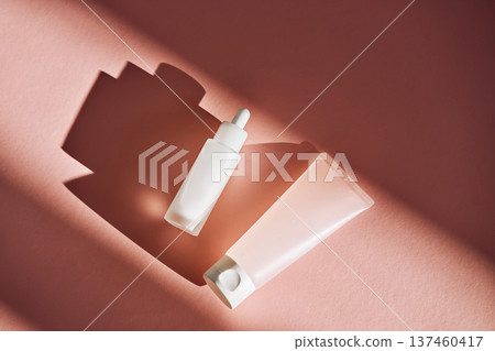 Skincare dropper bottle and tube with shadows Skincare dropper bottle and tube with shadows 137460417