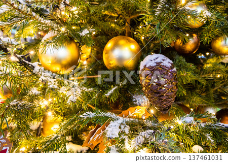 balls and cone on snow-covered christmas tree 137461031