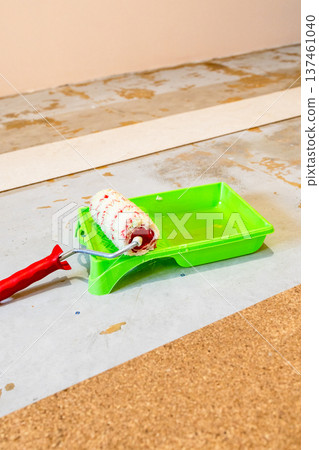 roller lies on tray for gluing cork tiles roller lies on tray for gluing cork tiles 137461040