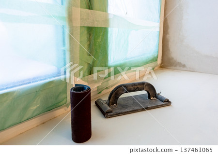 plastering board and sandpaper on plastered sill 137461065