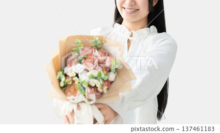 Smiling woman handing over a bouquet of flowers - Mother's Day image Smiling woman handing over a bouquet of flowers - Mother's Day image 137461183