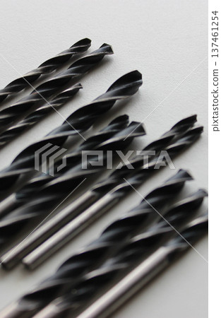 Black Drill Bits For Metal On Clean White Plastic Sheet WIth Selective Focus Black Drill Bits For Metal On Clean White Plastic Sheet WIth Selective Focus 137461254