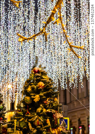 decorated christmas tree and outdoor garlands 137461284