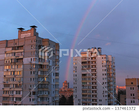 Cityscape with a rainbow between multi storey houses in the evening  137461372