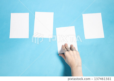 top view of hand takes sheet of white papers top view of hand takes sheet of white papers 137461381