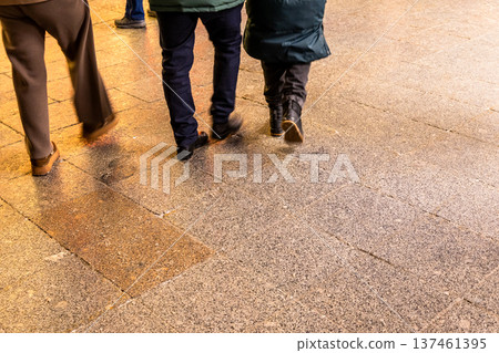 people walk on wet slippery tiles on street 137461395