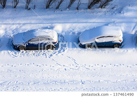 aerial view of snow-covered cars near city garden 137461490