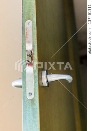 lock tongue on green painted wooden door close up 137461511