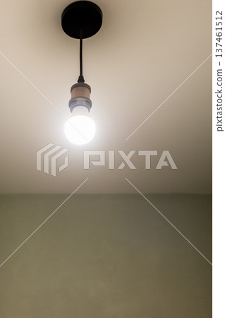 glowing light bulb hangs on electrical wires glowing light bulb hangs on electrical wires 137461512