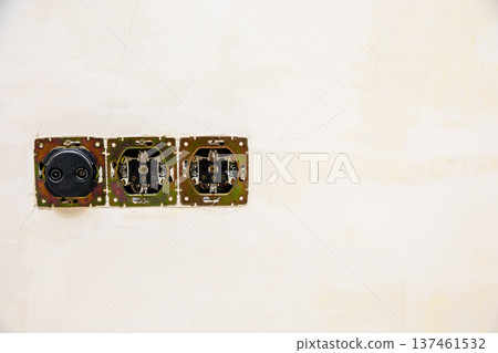 disassembled electrical socket and antenna on wall 137461532