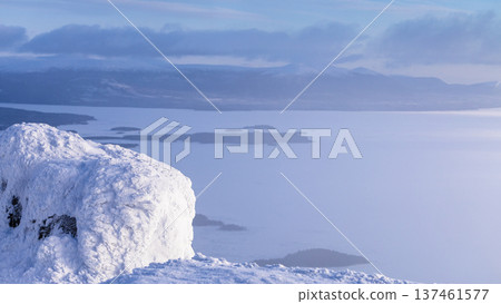 frozen rock and view of Kandalaksha bay in haze frozen rock and view of Kandalaksha bay in haze 137461577